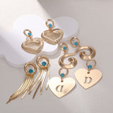 Orecchini da donna con zirconi intarsiati e diamanti a forma di cuore con nappa